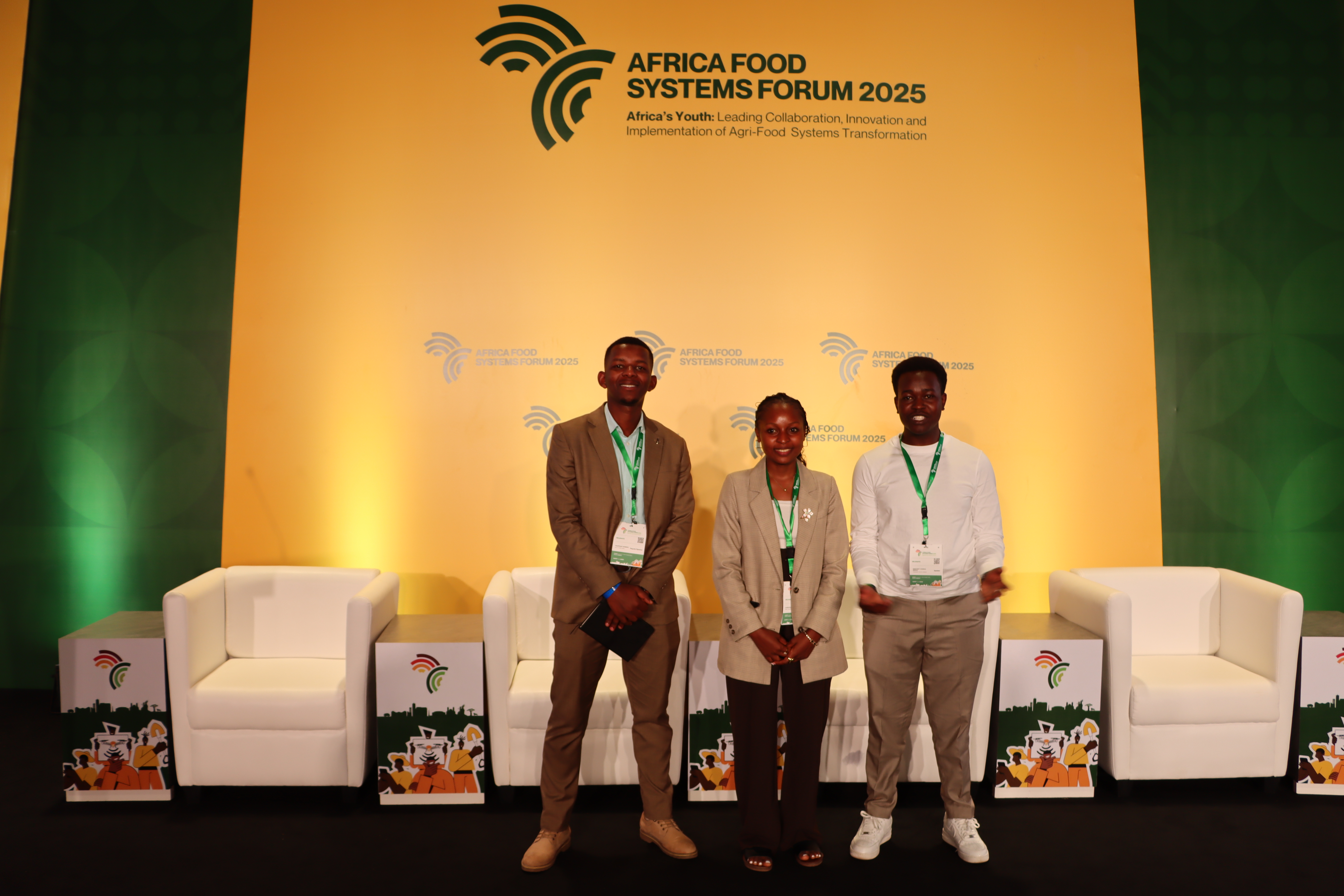 Three youth advocates standing on the Africa Food Systems Forum 2025 stage