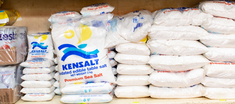 Small packages of salt in a market with blue title