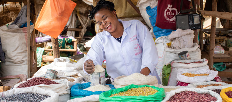 Smiling woman selling beans