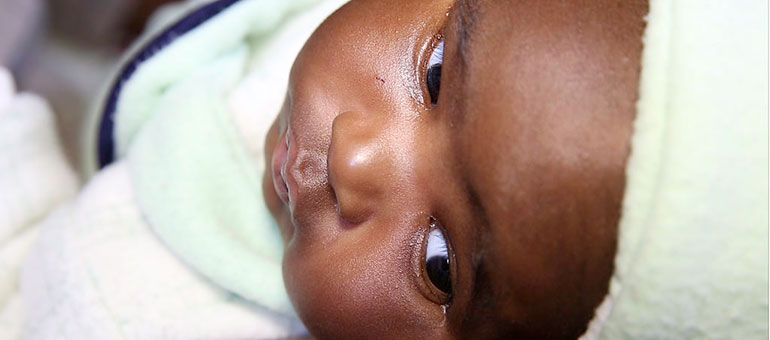 Baby dressed in white and blue, Africa