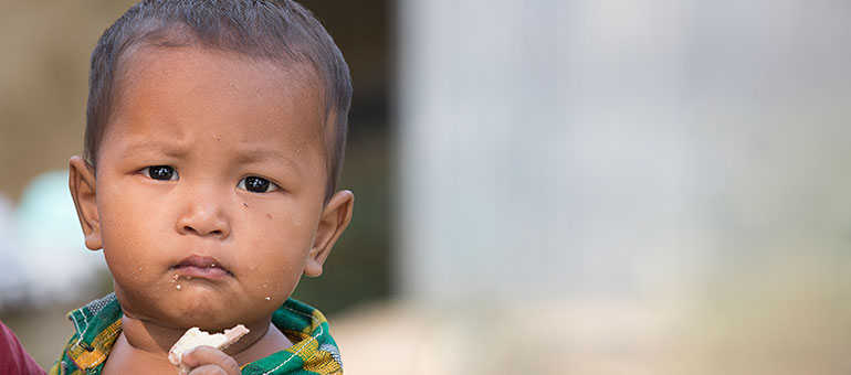 Baby eating fruit, Bangladesh, November 2018