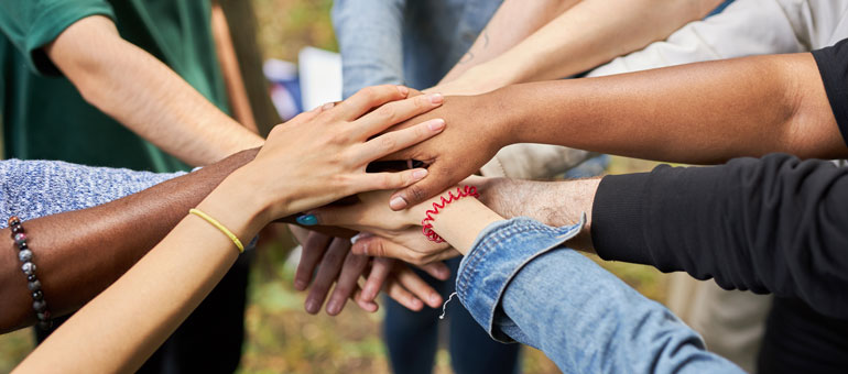 Different hands piled together 