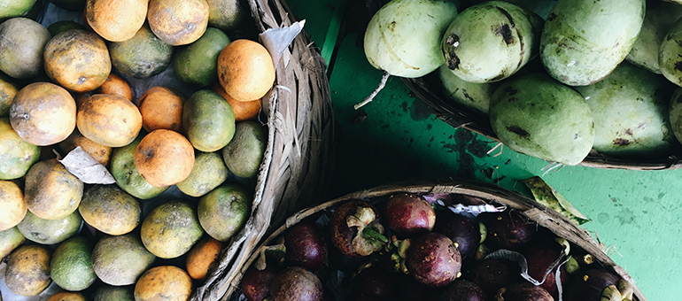 Fruits in baskets on a green background