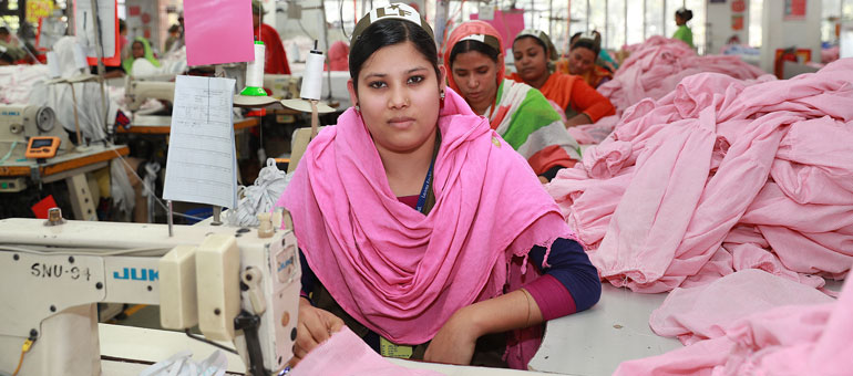 Garment worker with pink headscarf