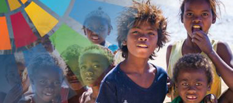 kids-looking-at-the-camera-behind-global-goals-logo