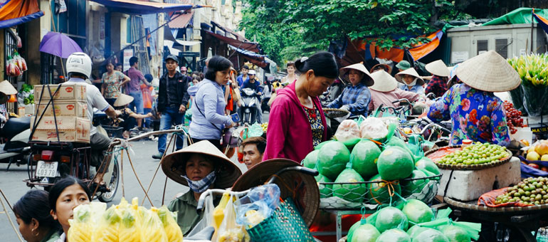 People in Hanoi market wearing typical hats 