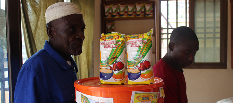 Two men standing next to a snack box