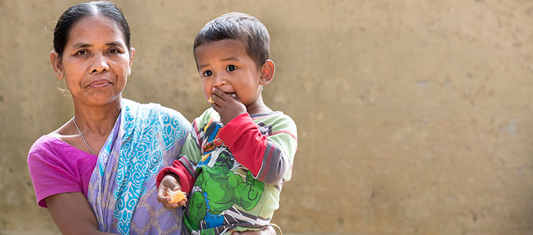 Woman holding child in her arms in Bangladesh