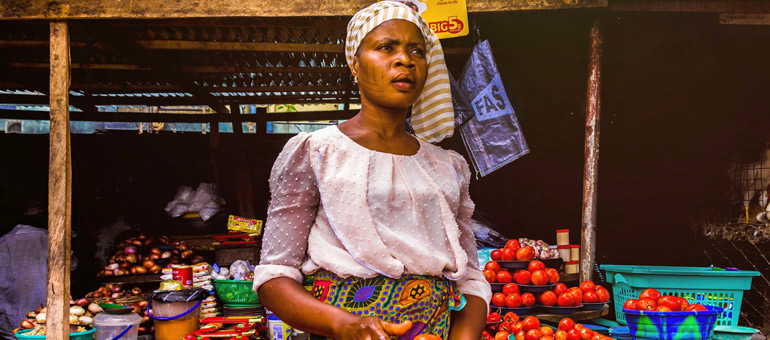 Woman selling tomatoes in Nigeria
