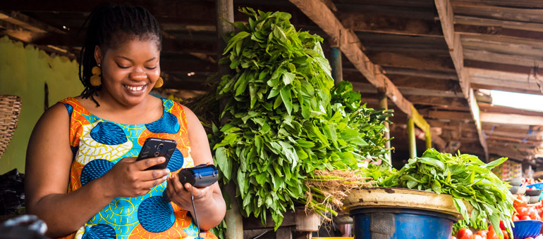 woman using her phone at the market