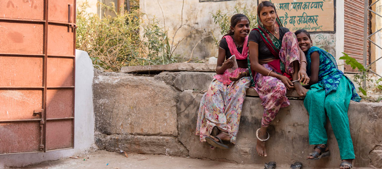 Woman with two girls sitting on a bench