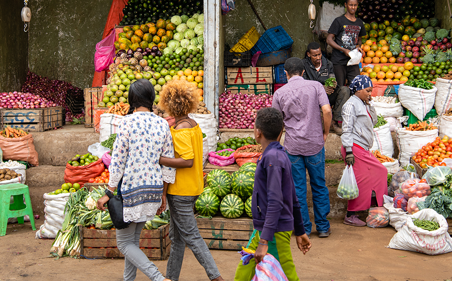 a shot of people shopping for fruits in an Ethiopian market