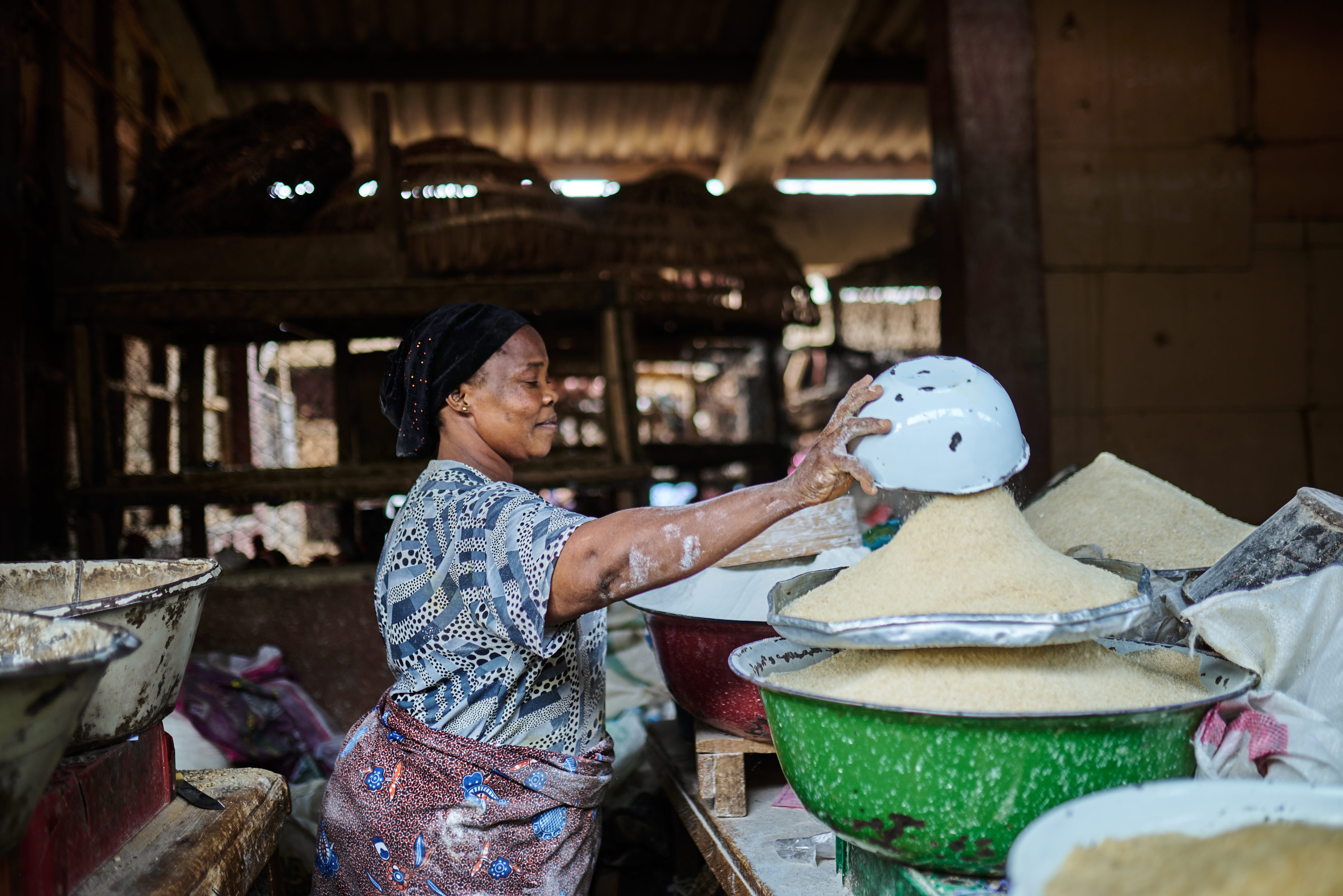 Woman emptying a bowl of flour