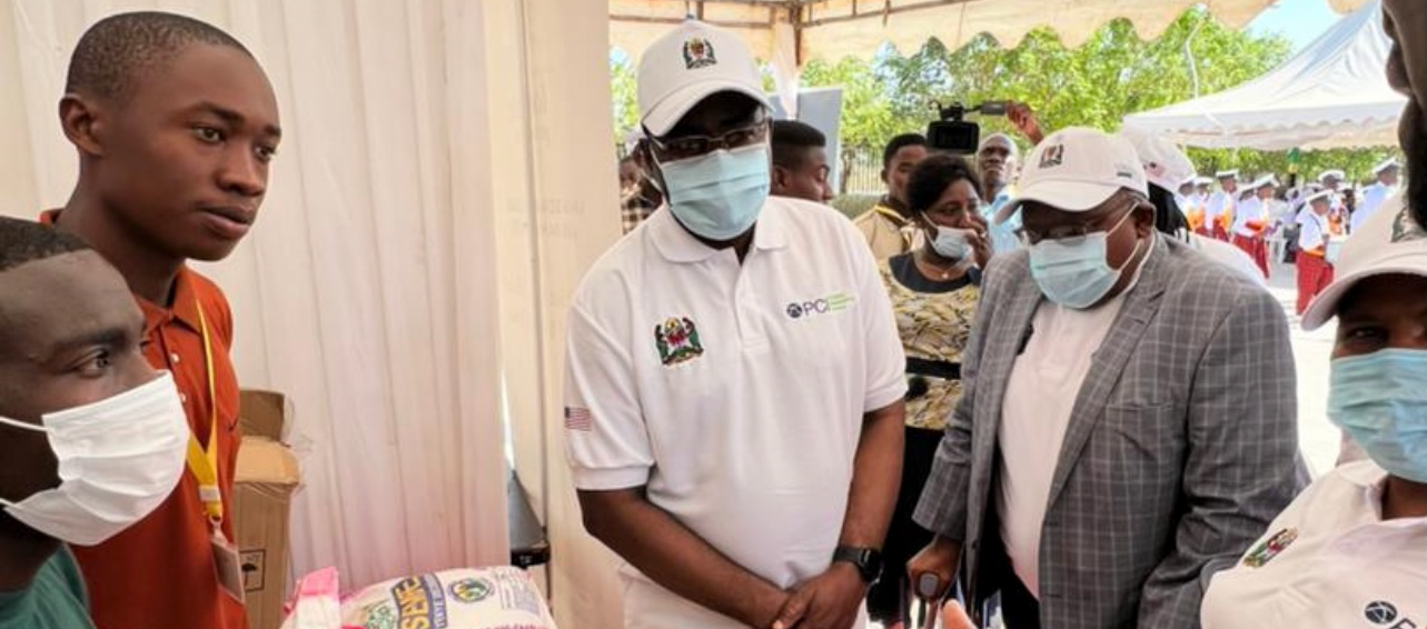 permanent secretary visiting a food booth at the launch of Tanzania's first national school feeding guidelines