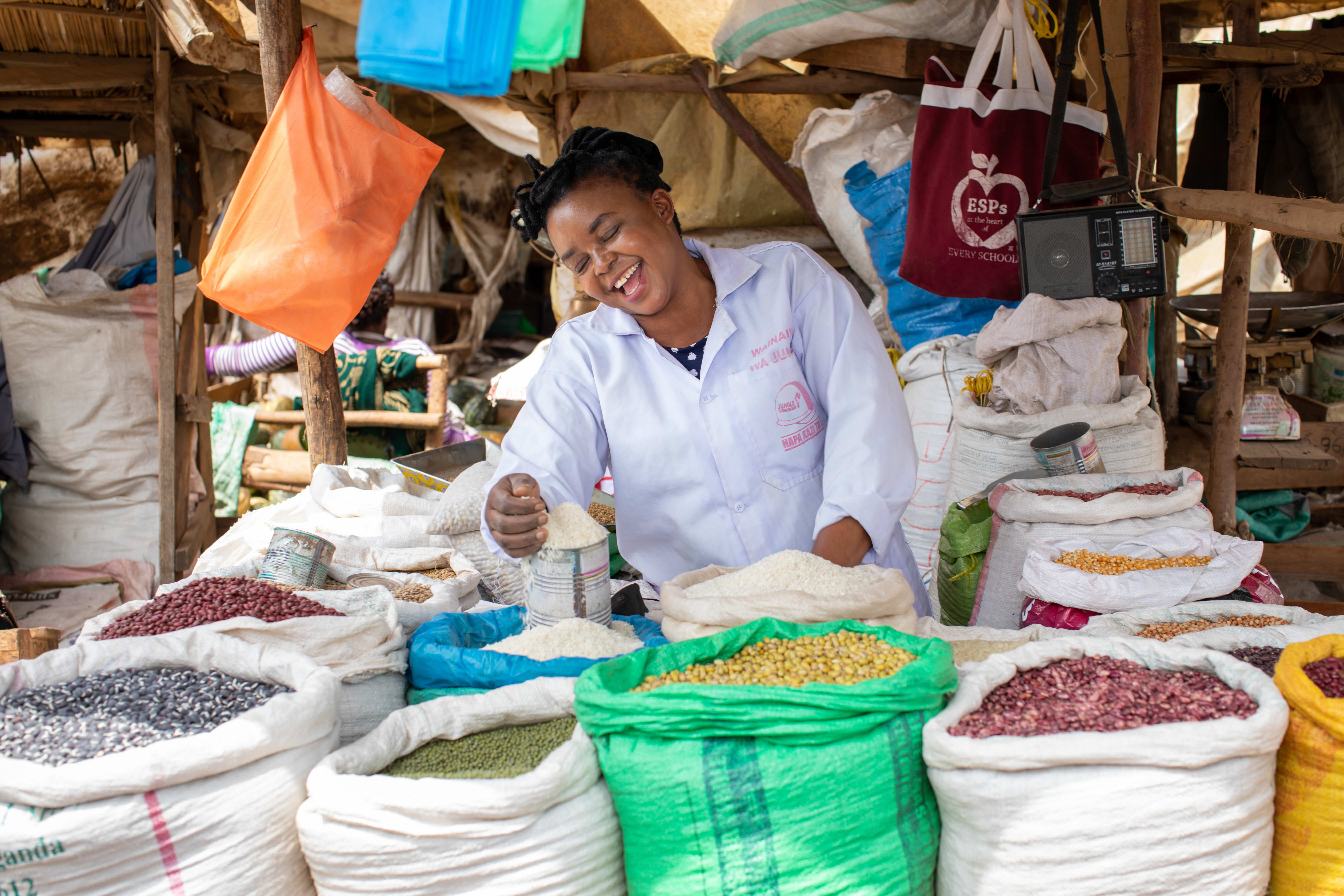 Smiling woman selling beans in Rwanda
