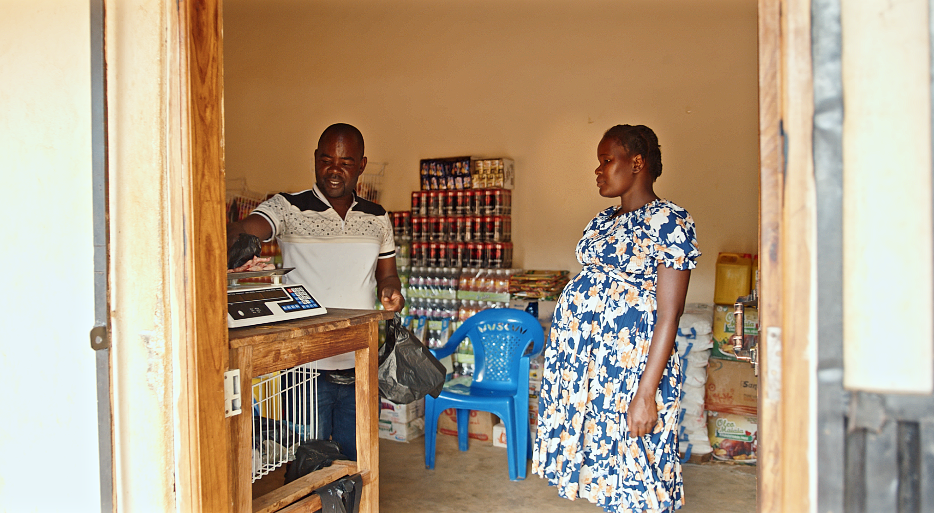 A customer purchasing food at a local shop in Tehene