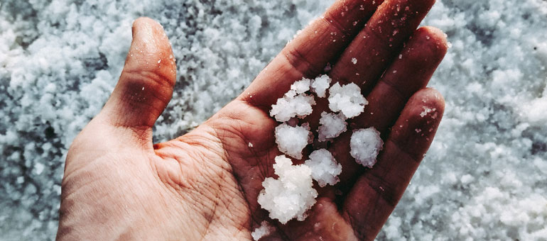 Close shot of a hand holding salt