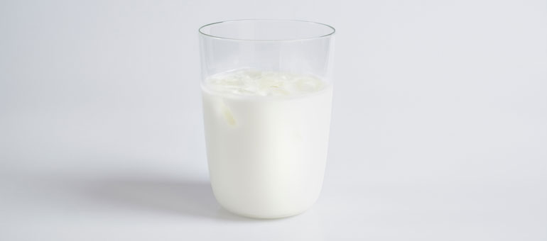 Glass of milk splashing