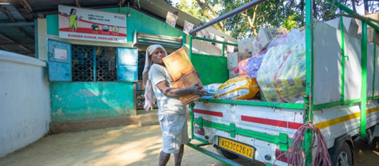 Man discharging a van and holding a heavy box