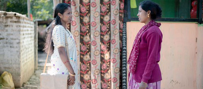 Two women talking in the road in India