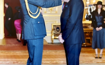 Lawrence being awarded the CMG medal by Prince William