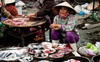 Woman selling fish in Asia Woman selling fish in Asia