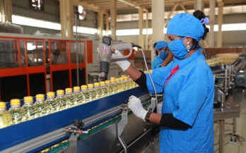 Woman working in oil factory in Bangladesh