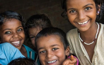 Kids smiling with colorful shirts