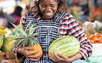 a vendor holding fruit a vendor holding fruit