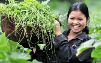 Woman smiling while holding a basket with grass