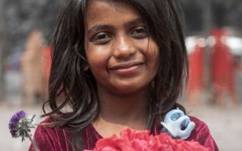Young girl in Bangladesh holding red roses Young girl in Bangladesh holding red roses