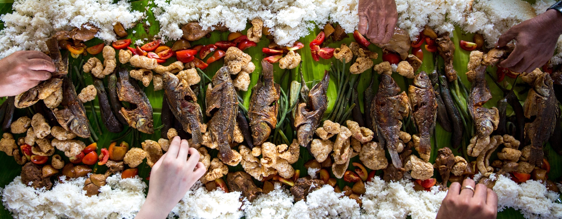 People eating rice and fish
