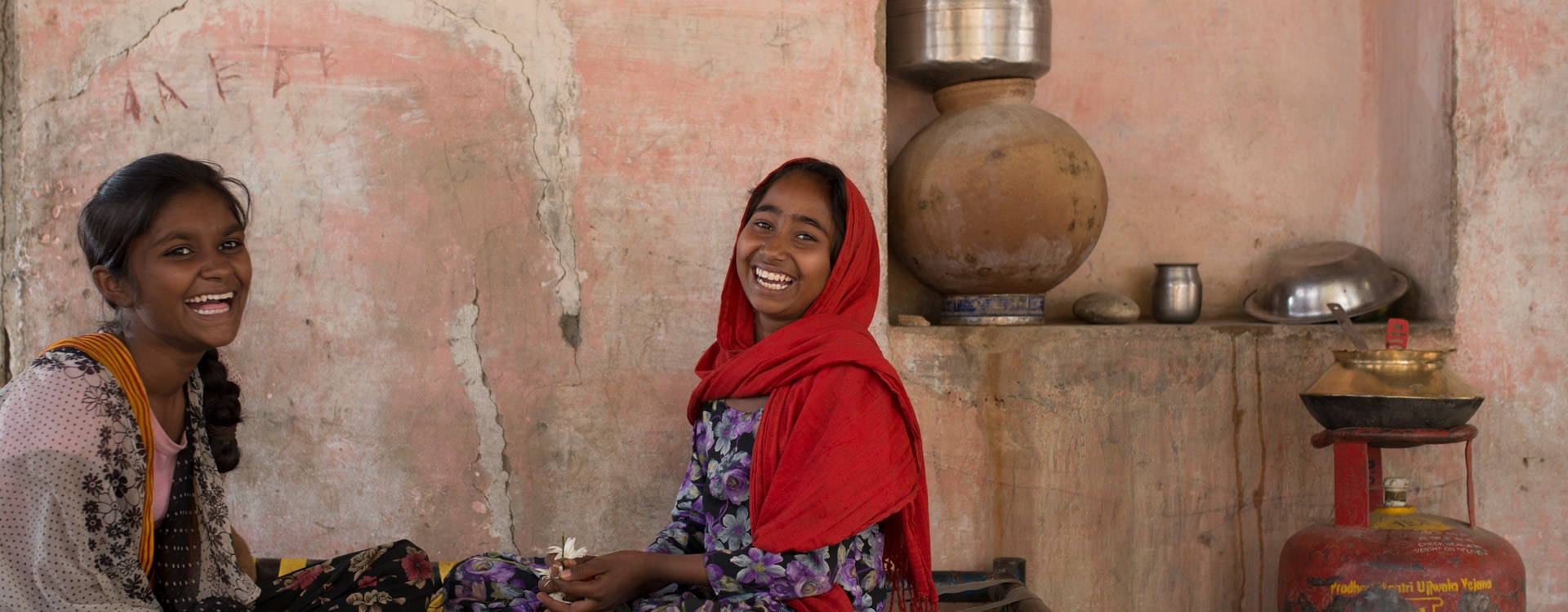 Two young girls in India laughing and smiling