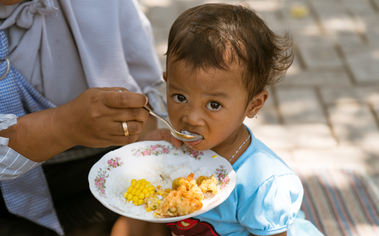 a child eating rice