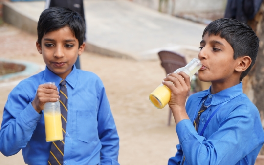 Two young boys drinking milk