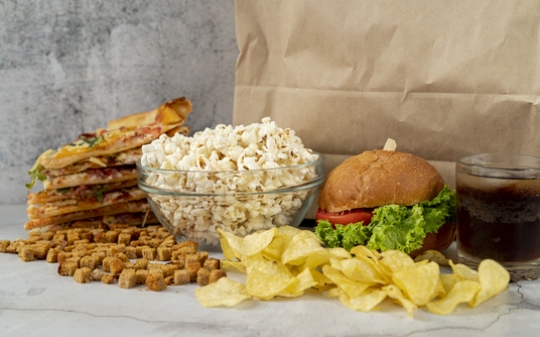 Photo of popcorn, burger and potato crisps