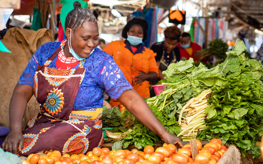 woman buying vegetables in a market