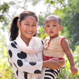 Girl holding sister and smiling
