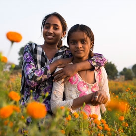 Two girls in a dandelions field in India