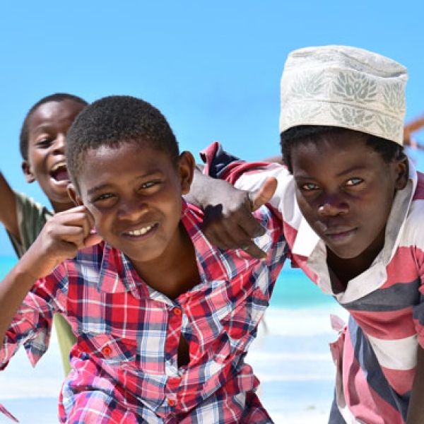 Three boys on the beach in Tanzania